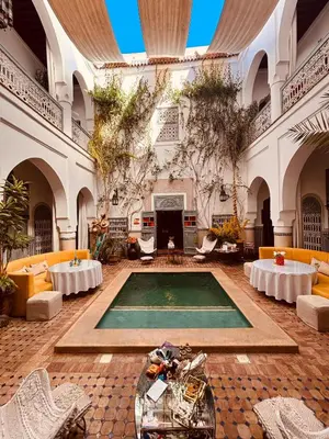 a large room with a swimming pool in a building at Riad Dar Al Assad in Marrakech