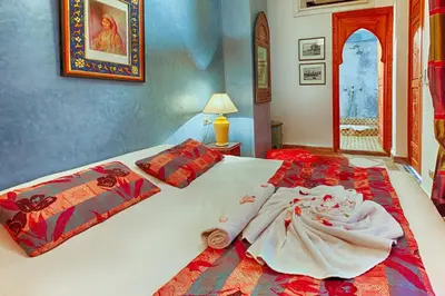 a bedroom with a bed with towels on it at Riad Kenzo in Marrakech