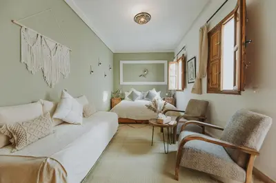 a living room with a couch and a bed at Riad Dar Coram in Marrakech