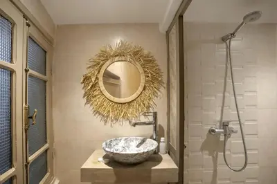 a bathroom with a bowl sink and a mirror at Riad El Kennaria in Marrakech