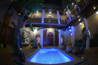 a swimming pool in the middle of a building at Riad Hidden in Marrakech