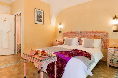 a bedroom with a large bed and a table at Villa Des 3 Golfs in Marrakech