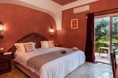 a bedroom with a large bed and a large window at Villa Des 3 Golfs in Marrakech