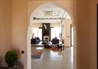 an archway leading into a living room with couches at Villa Nelya in Marrakech