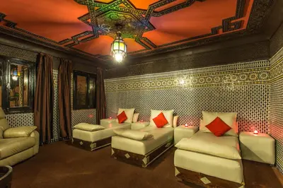 a living room with white couches and red pillows at Villa Amira & Spa in Marrakech