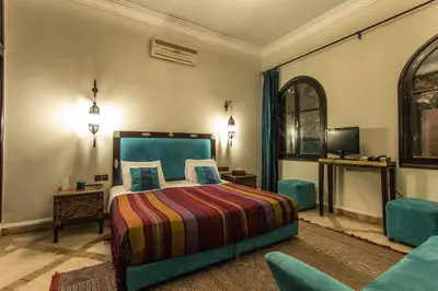 a hotel room with a bed and a tv at Villa Amira & Spa in Marrakech