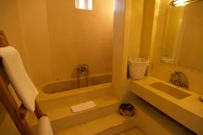a bathroom with a tub and a sink at Dar Crystal in Marrakech