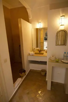 a bathroom with a sink and a mirror at Dar Crystal in Marrakech