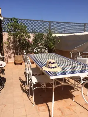 a blue and white table and chairs on a patio at Riad Irene in Marrakech