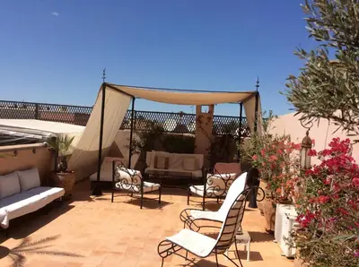 a patio with chairs and a gazebo at Riad Irene in Marrakech