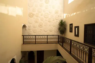 a staircase in a house with a wall with a mural at Riad Houdou in Marrakech