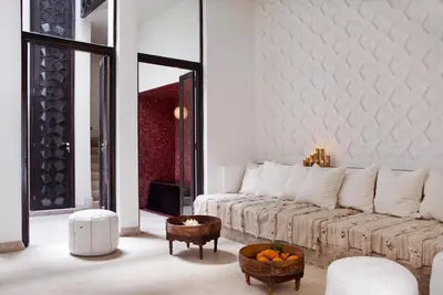 a white living room with a couch and a table at P´tit Habibi in Marrakech