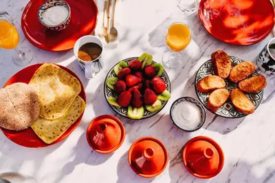a table topped with plates of food and fruit at P´tit Habibi in Marrakech