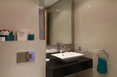 a bathroom with a sink and a mirror at golf city Av Med VI in Marrakech