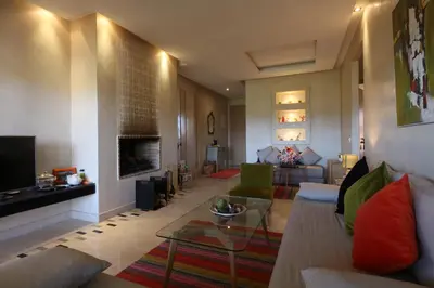 a living room with a couch and a table at golf city Av Med VI in Marrakech