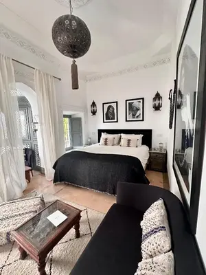 a bedroom with a bed and a couch and a table at Riad Hadika Maria in Marrakech