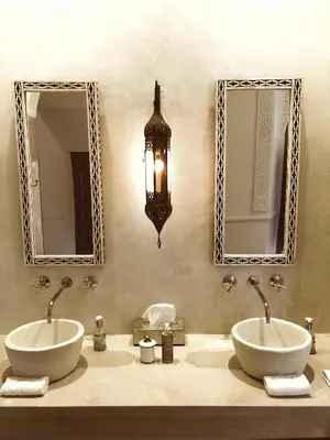 a bathroom with two sinks and two mirrors at Riad Hadika Maria in Marrakech