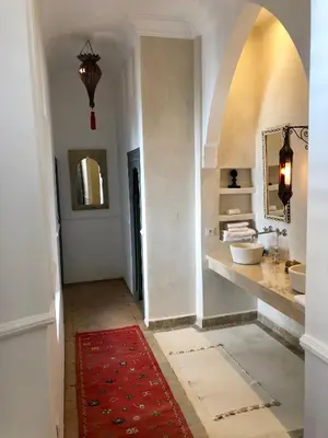a bathroom with two sinks and a red rug at Riad Hadika Maria in Marrakech