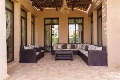 a patio with couches and a table and windows at Marrakech Pearl in Marrakech
