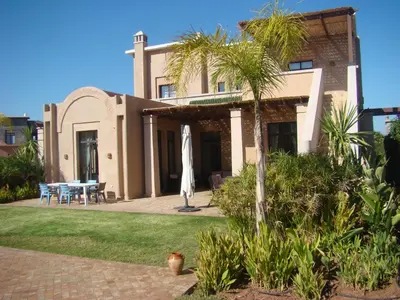 a house with a patio and a table in front of it at Marrakech Pearl in Marrakech