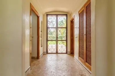 an empty hallway with a large window and a door at Marrakech Pearl in Marrakech