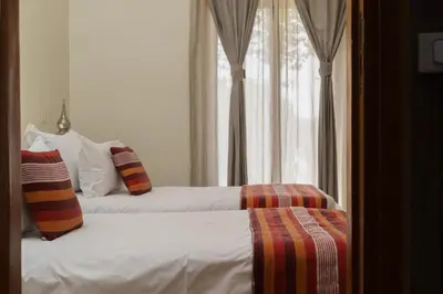a bedroom with two beds and a window at Marrakech Pearl in Marrakech