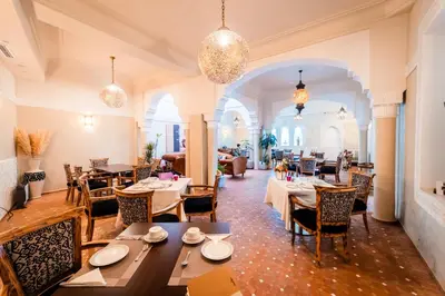 a restaurant with tables and chairs in a room at Ysalis Riad Restaurant & Spa in Marrakech