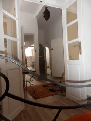 a glass table in a room with a hallway at Dar Habache in Marrakech