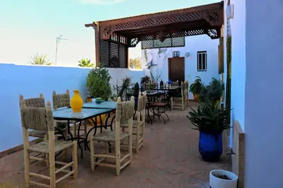 a patio with a table and some chairs and a table and chairsktop at Dar Habache in Marrakech