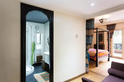 a mirror in a room with a bedroom at The Sapphire Apartment with Private Swimming Pool & Hot Tub - Hivernage Quarter - By Goldex Marrakech in Marrakech
