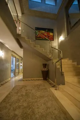 a hallway with stairs and a painting on the wall at Villa Loubane in Marrakech