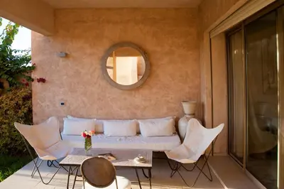 a living room with a couch and chairs on a patio at Villa Loubane in Marrakech