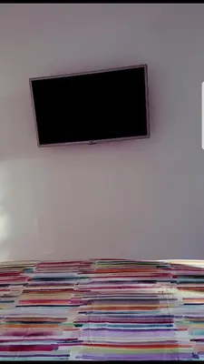 a flat screen tv hanging on a white wall at Oxygène in Marrakech