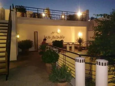 a man standing on the balcony of a building at night at Riad Tchina in Marrakech