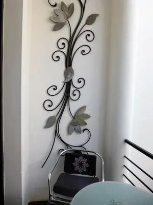 a wall art with a flower on a wall at Riad Tchina in Marrakech
