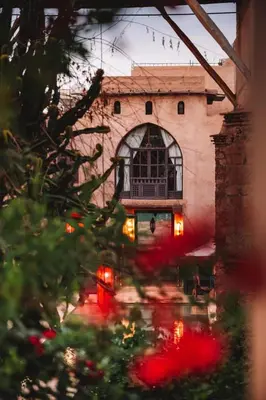 a building with a window and red lights on it at Caravan Serai in Douar Khalifa Ben Mbarek
