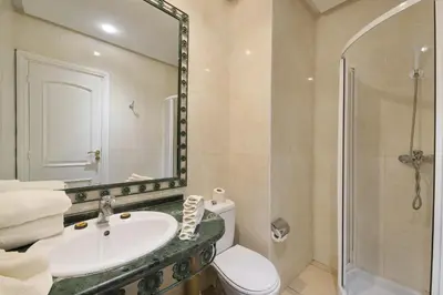 a bathroom with a toilet and a sink and a shower at Mogador Menzah Appart Hôtel in Marrakech
