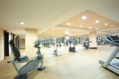 a gym with several treadmills and cardio machines at Grand Mogador Menara & Spa in Marrakech