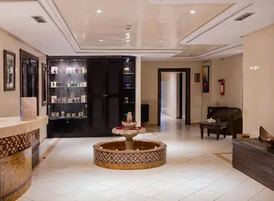 a lobby of a hotel with a table in the middle at Grand Mogador Menara & Spa in Marrakech