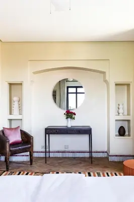 a room with a table with a vase of flowers on it at Villa de Luxe avec Piscine Privée et Golf in Marrakech