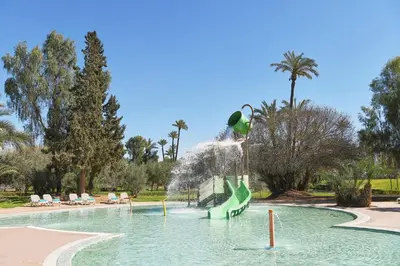 a pool with a water slide in a park at Iberostar Waves Club Palmeraie Marrakech All Inclusive in Marrakech
