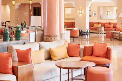 a lobby with a couch and tables and chairs at Iberostar Waves Club Palmeraie Marrakech All Inclusive in Marrakech