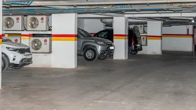 a car garage with two cars parked in it at Appartements Marrakech Garden in Marrakech