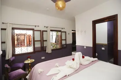 a bedroom with a bed with towels on it at Riad Heklek in Marrakech