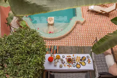 an overhead view of a table with food and a pool at Indian Palace in Marrakech