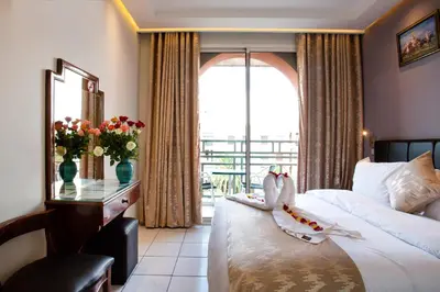 a hotel room with a bed and a balcony at Hotel Akabar in Marrakech