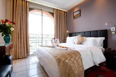 a bedroom with a bed with two swans on it at Hotel Akabar in Marrakech