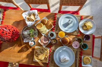 a wooden table with plates of food on it at Riad El Jadide in Marrakech