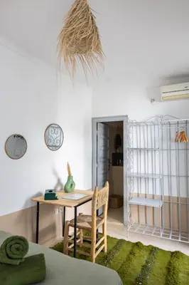 a room with a desk and a table with a chair at Riad El Jadide in Marrakech