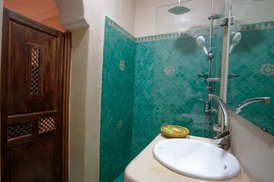 a bathroom with a sink and a shower at Riad Darino Marrakech Heritage in Marrakech